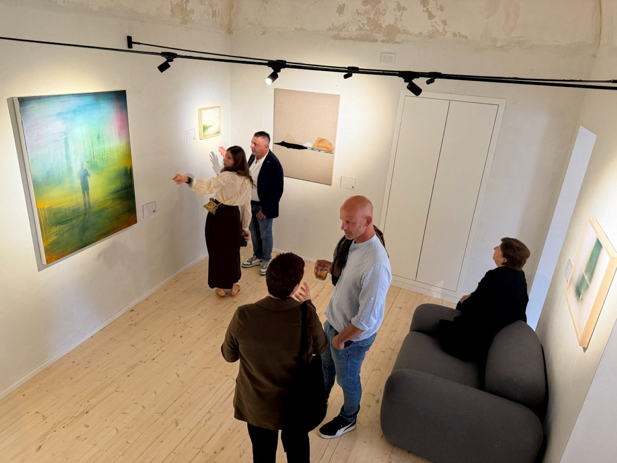Visitors viewing artworks at the Mosaica exhibition at Nomad Art Collective
